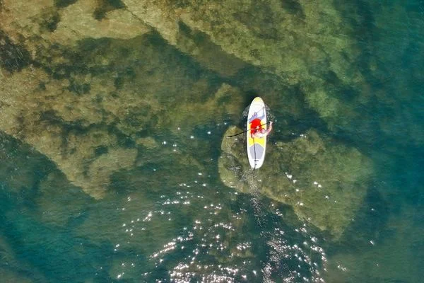 Aerial Photography of Person Paddle Boarding